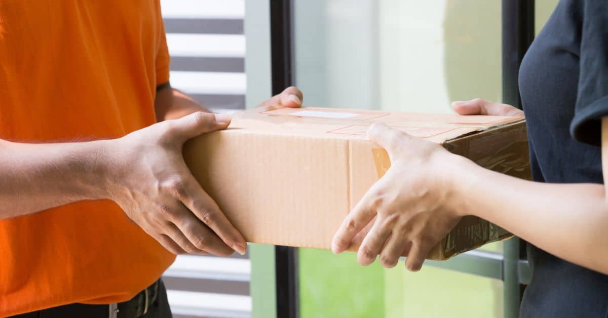 delivery staff handing a box to the customer